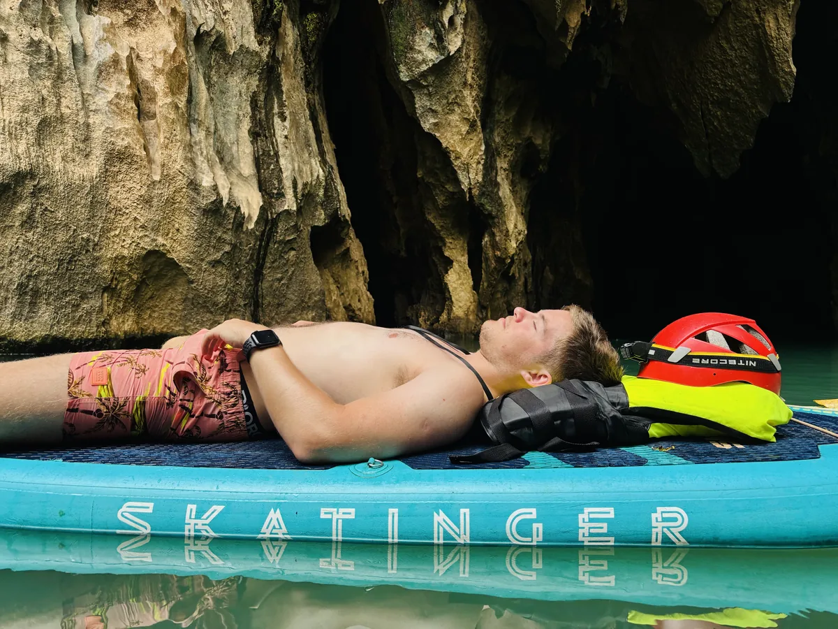 Swimming in cool emerald water at E Cave entrance after morning trekking